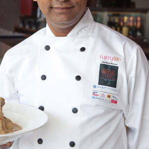 Chef wearing White EKO Long Sleeved Chef Jackets with Black Poppers