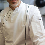 Chef wearing Pegasus White Long Sleeve French Cuff Chef Jackets with Black Piping